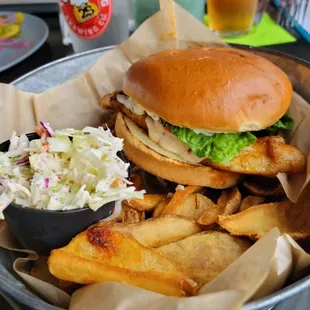 Blackend grouper sandwich with fries and coleslaw.