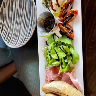 Burrata plate with prosciutto, arugula, roasted tomato , fig jam