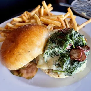 The Steakhouse Burger garnished with lemon spinach and fried radish chips, brioche bun; house frittes