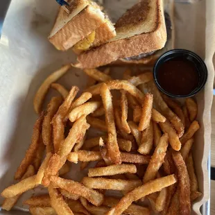 a tray of french fries and a sandwich
