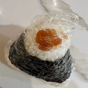 a piece of sushi wrapped in plastic