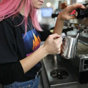 a female bari serving a cup of coffee