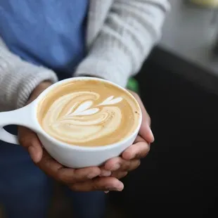 a person holding a cup of coffee