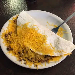 a plate with a burrito and a fork