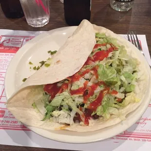 a taco and salad on a plate