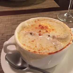 a bowl of soup on a plate with a spoon