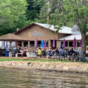 a group of people sitting outside of a restaurant