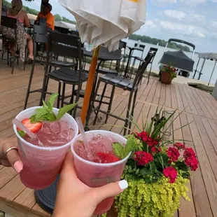 two people holding drinks