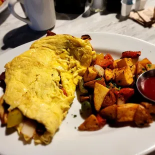 an omelet with a side of potatoes