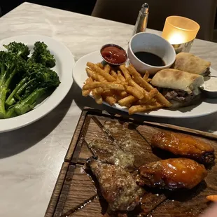Broccolini side dish and French dip sandwich with fries.