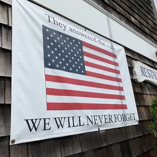 an american flag hanging on the side of a building