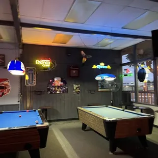 two pool tables and a television