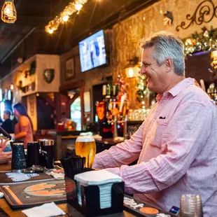 two men standing at a bar