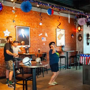 people in a restaurant with a brick wall