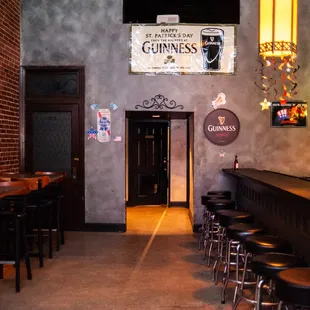 a bar with stools and tables
