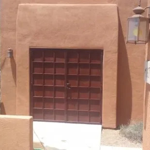 Double French door as an enclosure. Perforated metal screening with a Rust Finish.