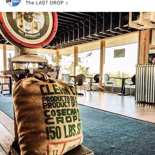 a bag of coffee sitting on top of a suitcase