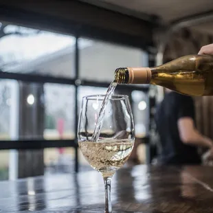 a glass of wine being poured