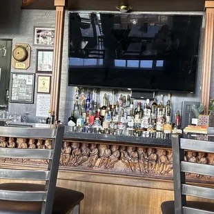 The hand carved bar with 2 of 4 chairs.