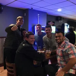 a group of men sitting at a table