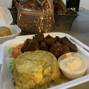 a plate of food and a bowl of sauce