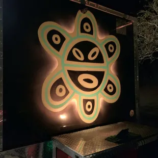 a sun symbol painted on the side of a truck