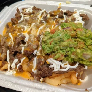 Carne Asada Fries. French fries topped with carne asada, guacamole, sour cream, and cheese. Large size pictured, $10.