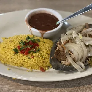 Lechon Asado with yellow rice and red beans