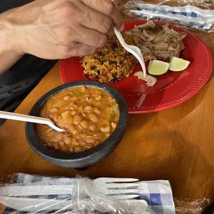Roast pork dish served with brown rice and red beans