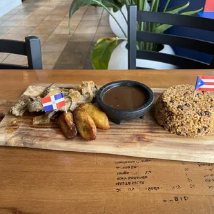 Beefsteak encebollada with Gandules ( Puerto Rican Rice)  black beans and sweet plantains .