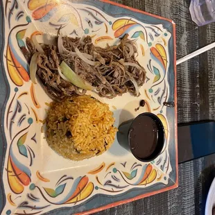 a plate of food with rice and beans