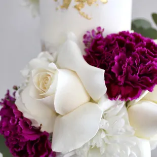 a white cake with purple and white flowers
