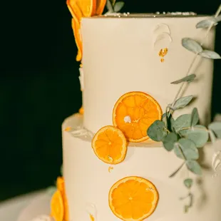 a white cake with oranges on top