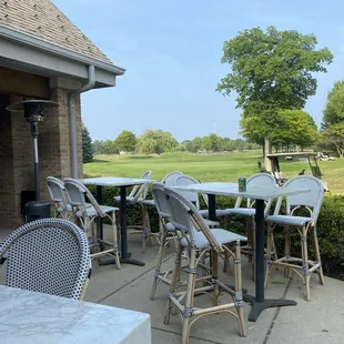 a patio with tables and chairs