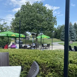 people sitting at tables with umbrellas
