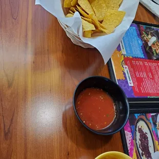 a bowl of chips and a bowl of salsa