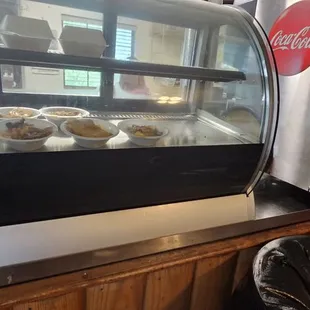 a display case with bowls of food