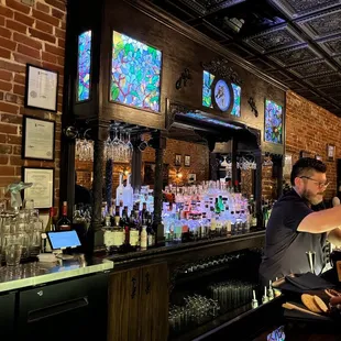 a man serving a drink at a bar