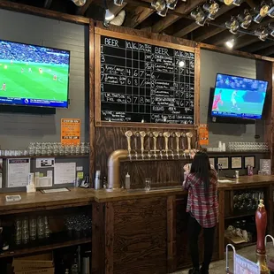 a woman standing in front of the bar