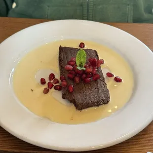 Chocolate terrine with crème anglaise. Pomegranate garnish.