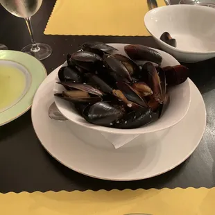 Large bowl of beautiful mussels in a white wine/garlic sauce.