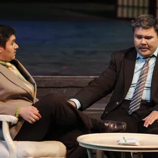 a man and a woman sitting on a stage