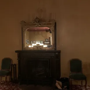 a fireplace and chairs