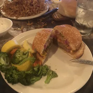 Senior cheeseburger and steamed veggies( Onion haystack in the background.)