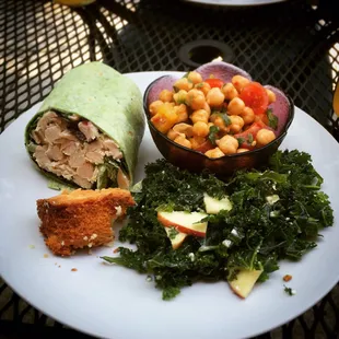 My lunch earlier today. It came with a drink too! Chicken salad wrap, spicy chickpeas, kale salad and blackberry cake bite.