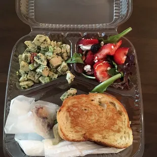 Spinach, chicken, artichoke sandwich, mixed green salad, and basil pesto chicken salad, drink, and small dessert bite.