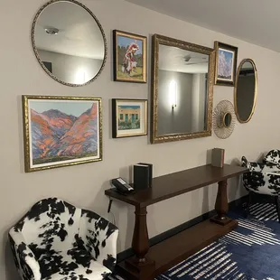 a hallway with chairs and mirrors