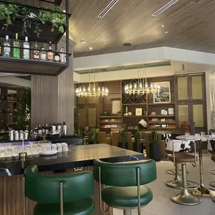 a bar with green chairs