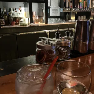 two glasses of water on a bar