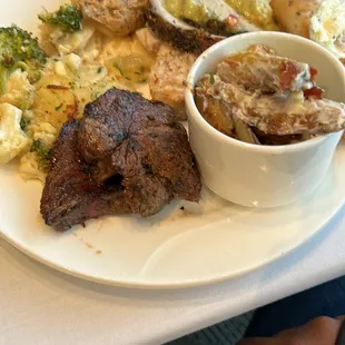 Beef petites, pork loin, potato salad, chicken, and broccoli
